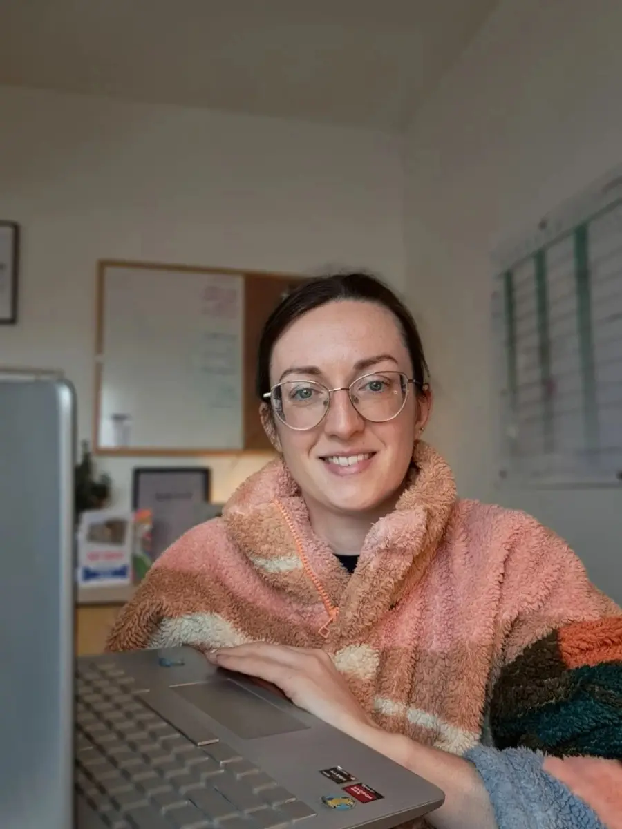 Rosy smiling at her laptop, ready for an online session