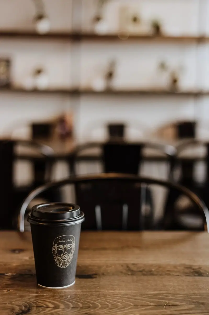 A takeaway coffee cup on a café table