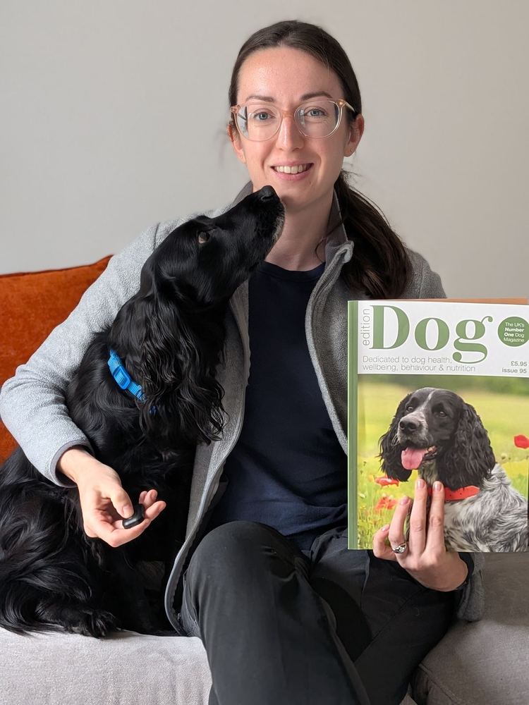 Rosy on the sofa with her spaniel and a copy of Dog magazine